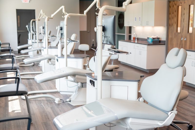 Row of treatment chairs in an open clinical bay