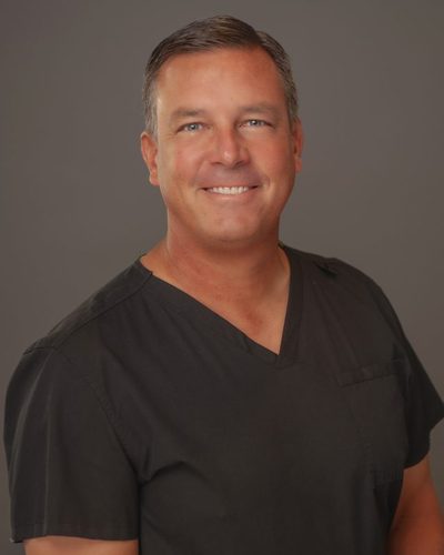 Dr. Steven Taylor, DDS, MS, smiling in a clinical portrait