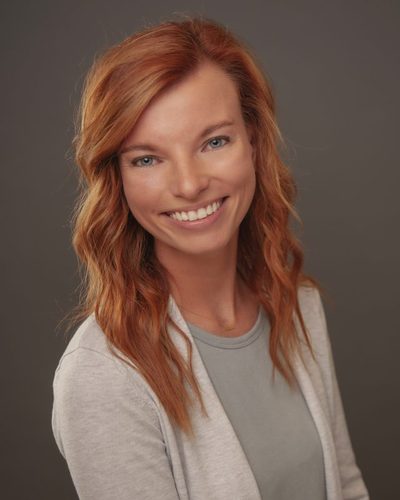 Emily Wallingford smiling, wearing a light cardigan