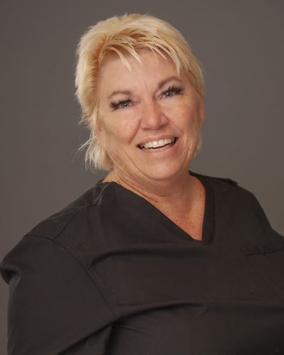 Lisa Maasen smiling, wearing black scrubs