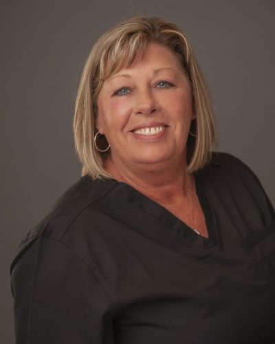 Loretta Sprinkles smiling, wearing black scrubs